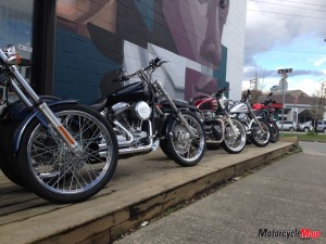 A lineup of Harley-Davidsons and Triumphs outside the _lifestyle & motrocycle boutique